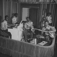 A band at the Equator Club. A five-piece African band perform on a small, confined stage at the