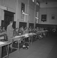 KNFU conference. Members of the Kenyan National Farmer's Union (KNFU) sit behind desks, taking