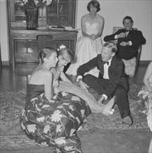 Frivolous behaviour. A young man dressed in a tuxedo teases a girl at the Orme-Smith 21st birthday