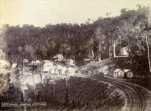 Ipswich railway station. Wooden buildings constructed on cleared forest land surround the track at