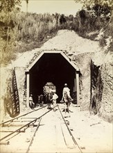 Horses at tunnel 'No. 15'. A group of men lead horses across newly laid railway tracks beneath