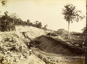 Railway construction site. Labourers at work on a construction site, landscaping a bank of earth to