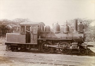 American steam locomotive. An American-manufactured steam locomotive sits on rails at a siding. A