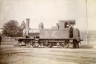 British steam locomotive, Jamaica. A British-manufactured steam locomotive sits on rails at a