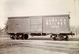 Box carriage, Jamaica. A box carriage inscribed 'Jamaica Railway 1033' sits on rails at a siding.