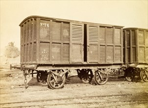 Jamaica Railway box wagon. An box railway wagon inscribed 'No. 76', sits on rails at a siding.