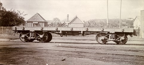 Jamaica Railway wagon. An open railway wagon sits on rails at a siding. Jamaica, circa 1895.