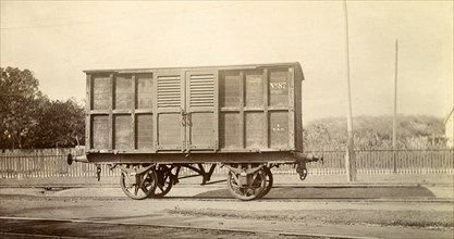 Jamaica Railway wagon. A closed railway wagon inscribed 'No.87', sits on rails at a siding.
