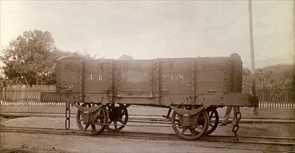 Jamaica Railway wagon. An open railway wagon inscribed 'J.R. No.128', sits on rails at a siding.