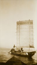 Sailing out to Nalaban Island. A small boat with a distinctive rectangular sail sets out for