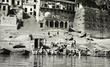 A bathing ghat at Benares. Religious pilgrims bathe at a ghat (stepped wharf) on the River Ganges