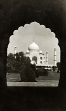 The Taj Mahal, circa 1925. View of the Taj Mahal, framed by an ornately-shaped doorway. Agra,