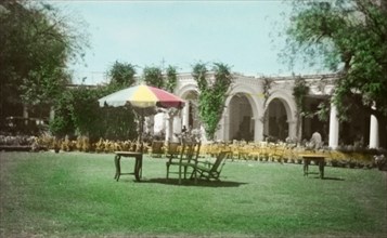 Laurie's Hotel, Agra. Deckchairs and a parasol, set up on the lawn outside Laurie's Hotel. Agra,