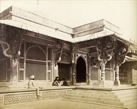 Salim Chisti's tomb. Two figures sit outside the entrance to Salim Chisti's tomb, built in 1570