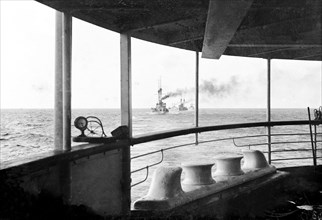 Battleships in escort. View from the deck of HMS Medina, the royal yacht transporting King George V