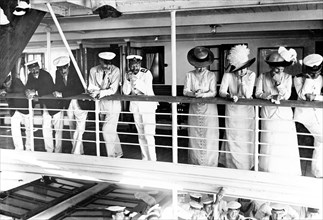 On board entertainment. King George V (r.1910-36), Queen Mary and her Ladies in Waiting are