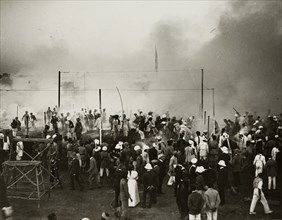 Fire at the Coronation Durbar. Onlookers face a cloud of smoke emitting from a fire at the
