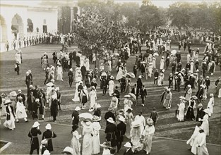Coronation Durbar garden party. Formally dressed guests socialise on the lawns outside the Delhi