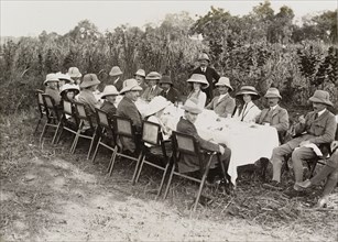 Royal lunch in the jungle. King George V (r.1910-36), seated fourth from left on the far side of