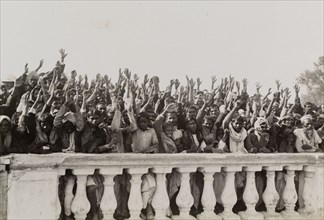 A loyal greeting for King George V's visit. An Indian crowd waves in greeting to a royal train