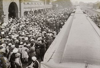 Greeting for King George V. An Indian crowd gathers on a railway platform, anxious to greet King