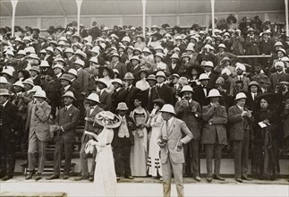 Spectators at a steeplechase. European, Indian and Eurasian spectators watch a steeplechase from