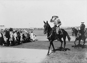 Duke of Connaught reviews the Volunteer Police. The Duke of Connaught salutes as he rides out to