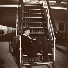 Seating arrangements on the S.S. Balmoral Castle. A passenger aboard the S.S. Balmoral Castle sits