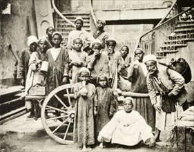 Arab children collect water. Portrait of a group of traditionally dressed Arab children, several of