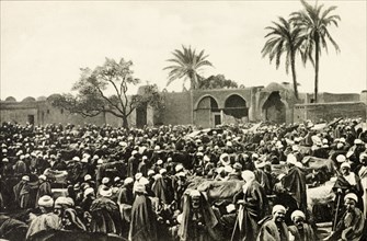 Market at Giza. A throng of people crowd an open air market at Giza. Giza, Egypt, circa 1900. Giza,