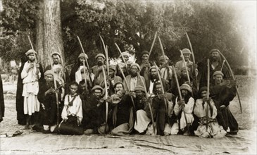 Kafir archers, Pakistan. A group of Kafir archers pose for the camera, their arrows pulled back as
