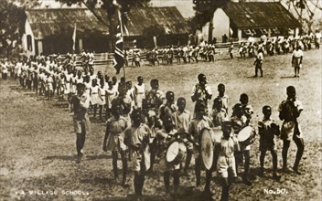 Gold Coast school parade. A procession of uniformed school children parade outdoors, displaying a