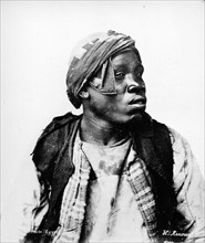 Portrait of a Nubian man. Semi-profile portrait of a Nubian man, dressed in unkempt clothing and a