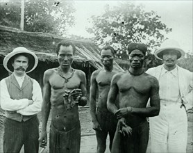 Congo Free State murders. Congolese rubber slaves display the severed hands of two fellow workers,