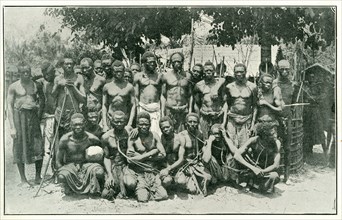 Congolese rubber slaves. Portrait of a group of male slaves, tied together with ropes around their