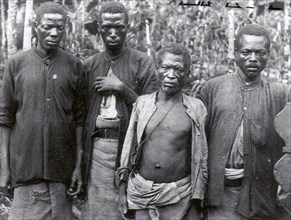 Indentured workers on Sao Tome. Portrait of four Angolan 'slaves', indentured workers employed on