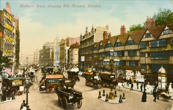Road junction in Holborn. A busy road junction in Holborn. Pedestrians and horse-drawn carts and
