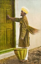 An Indian 'mehtar'. An illustration depicting a turbaned 'mehtar' (sweeper) visiting a house. He