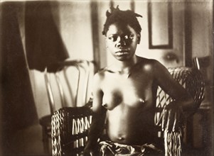 Young woman from Bioko. Portrait of a semi-naked young woman from Bioko, posed seated in a