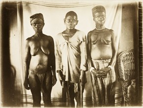 Inhabitants of Bioko. Portrait of a two women and a man from Bioko, posed standing against a