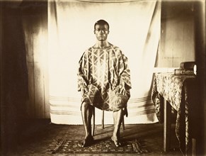 Young man from Bioko. Portrait of a traditionally dressed young man from Bioko, posed seated