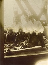 European men, African girls. Three European men accompany two African girls on what appears to be