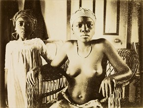 Inhabitants of Bioko. Portrait of a girl and a young woman from Bioko. Posed seated in a wickerwork