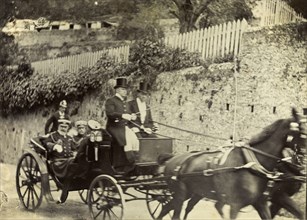 Horse-drawn carriage in Gibraltar. Two distinguished gentlemen are driven along a road by
