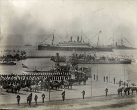 Royal steamship at Gibraltar. British soldiers parade on a dockside in honour of King Edward VII