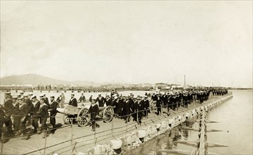 Naval troops at Gibraltar. British naval troops march along a quayside. One of several photographs