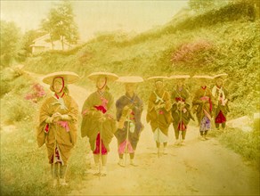 Japanese women. Seven Japanese women stand in line on a rural road. Traditionally dressed in