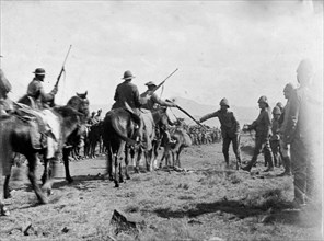 Boer fighters surrender at Slaapkrans. Boer fighters relinquish their rifles to British forces at
