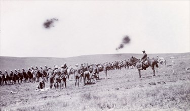 Fallen comrades during the Second Boer War. A mounted British cavalry unit prepares to remove its