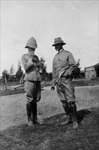 Two officers smoking, South Africa. Two uniformed British Army officers enjoy a cigarette outdoors